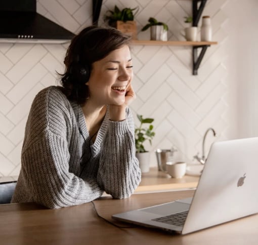 A woman participating in a video call on her laptop